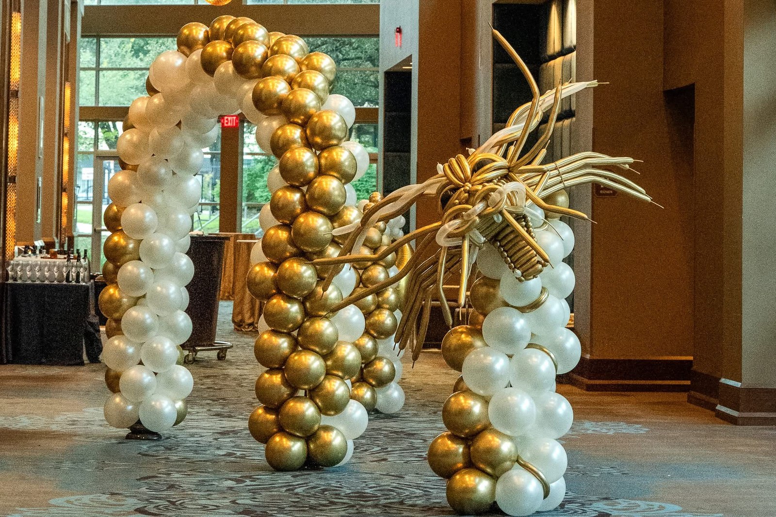 A sculptural gold and white balloon dragon installation at the Ovation Gala.