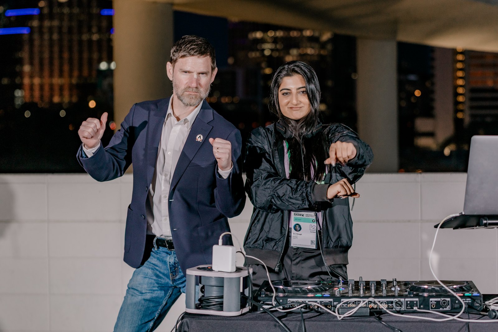 Guests enjoying music on an Austin rooftop after dark.