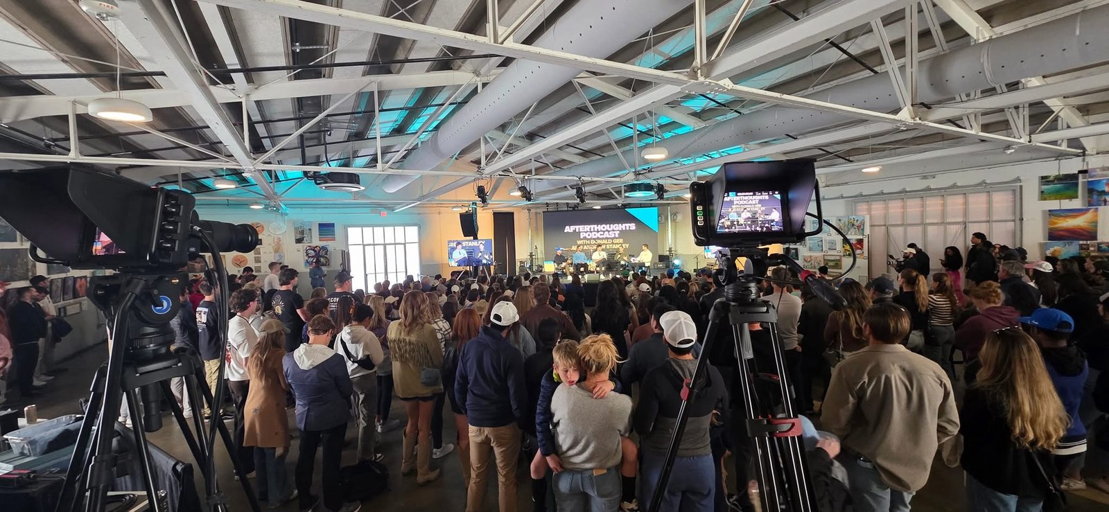 A room filled with attendees and production cameras at SVC during SXSW.